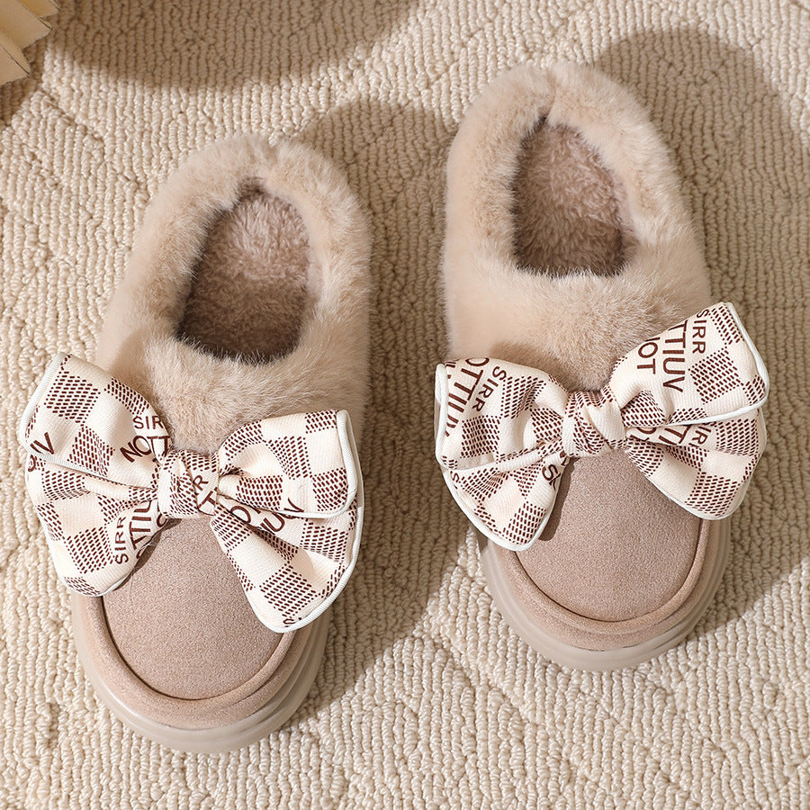 Fluffy winter slippers with bow on a cozy carpet, offering warmth and elegant style for home comfort.