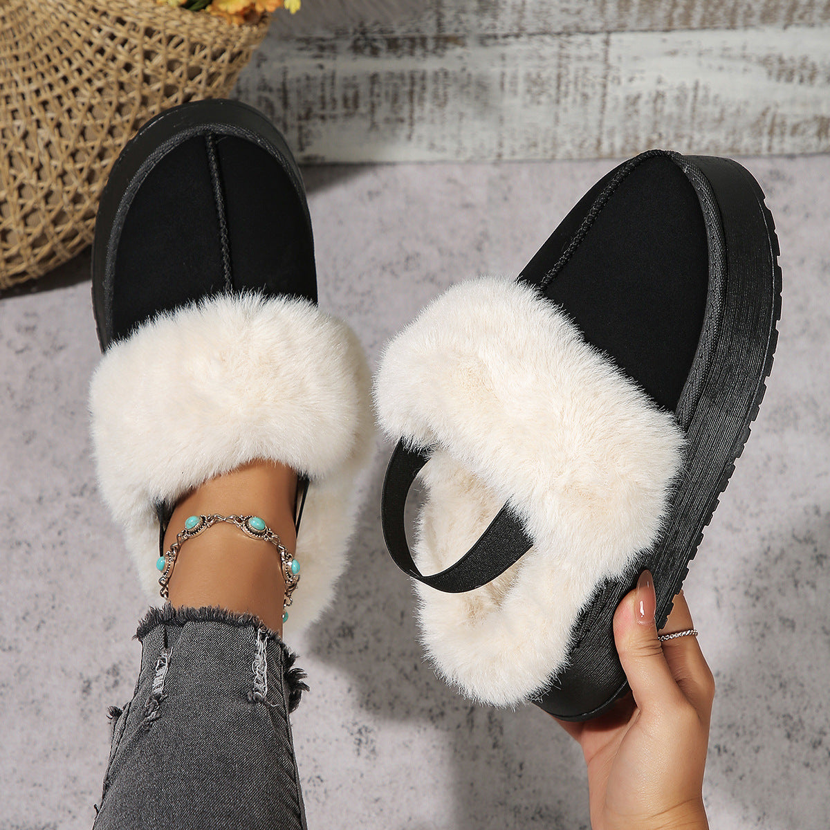 Warm black winter slippers with white fur and elastic heel strap, ideal for cold nights and home comfort enthusiasts.