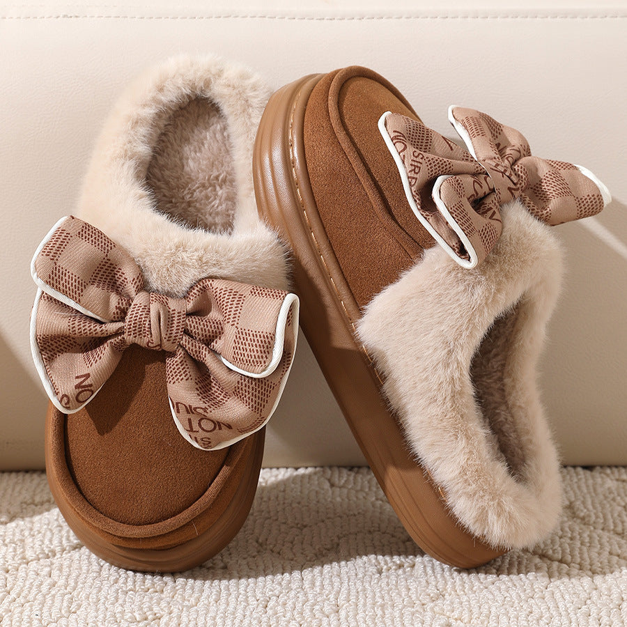 Fluffy winter slippers with bow, offering warmth and stylish comfort for cold months, featuring a plush design for home use.